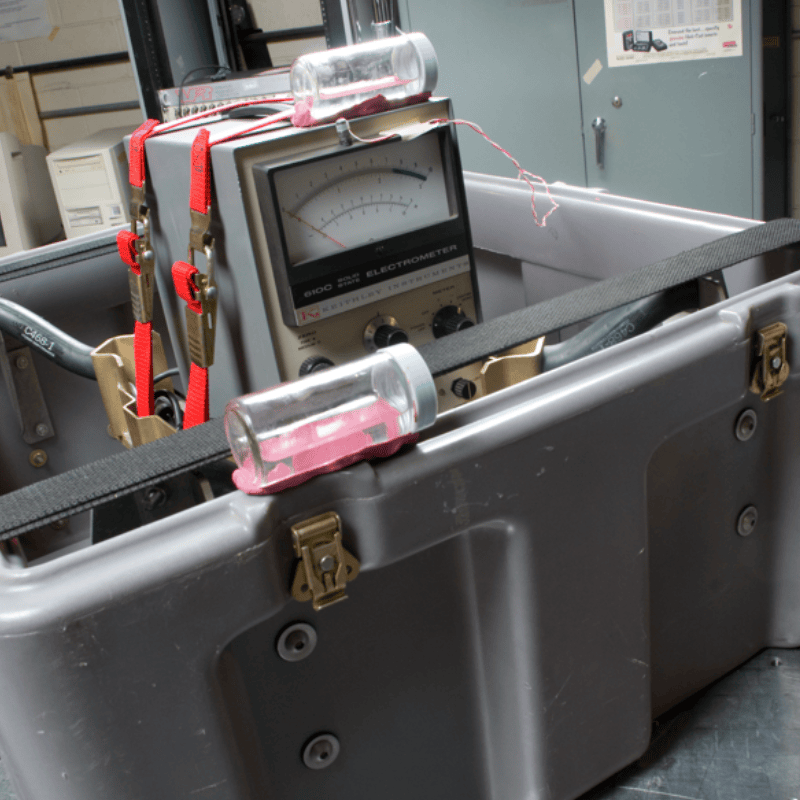Person handling a foldable professional drone from a custom foam-padded hard case, designed for secure field transport and rapid deployment.